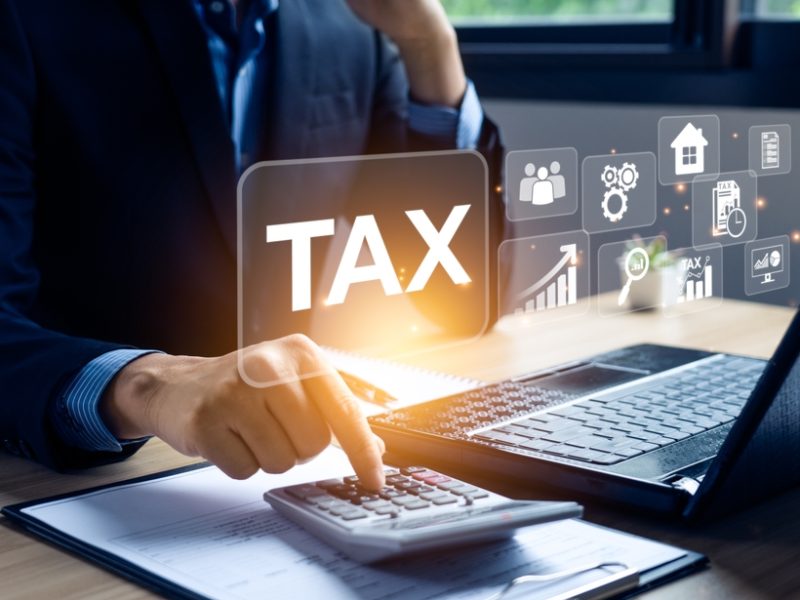 Businessman,Calculating,Annual,Taxes,And,Paying,Taxes.,Tax,Deduction,Planning